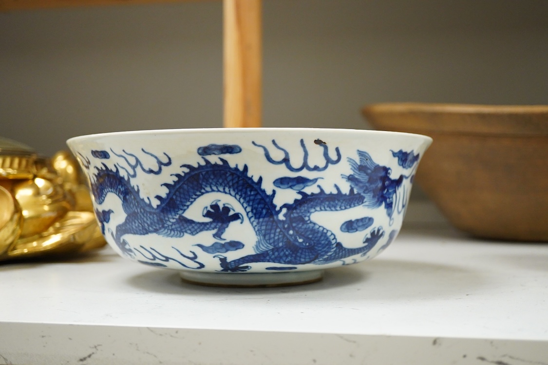 A Chinese blue and white dragon bowl, Kangxi mark but later, 26cm diameter